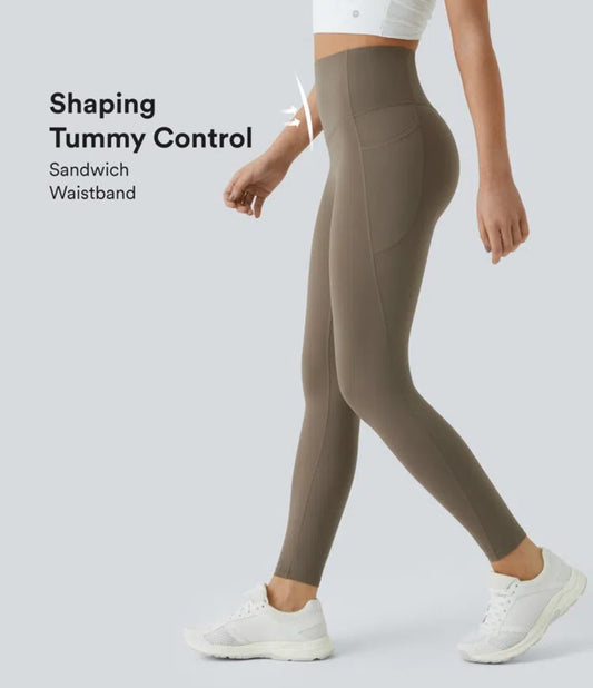 Brown leggings with shaping tummy control feature on a white background